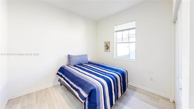 bedroom with baseboards and light wood-style floors