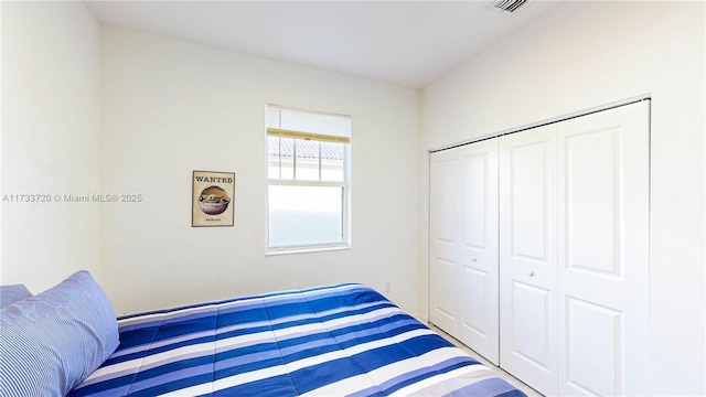 bedroom featuring visible vents and a closet