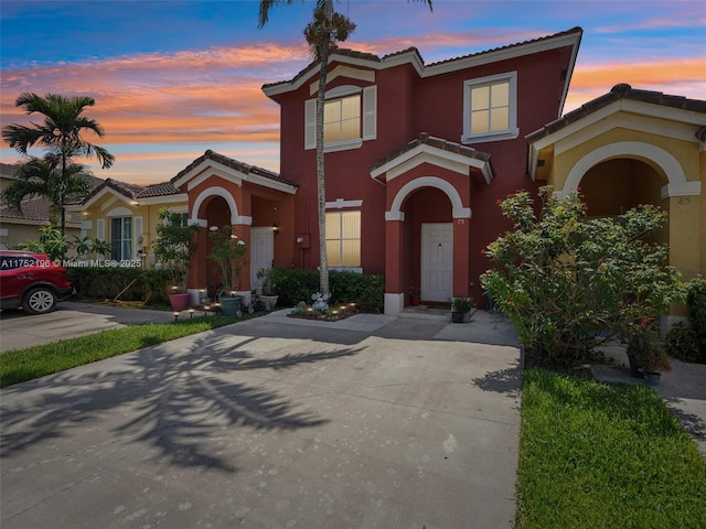 mediterranean / spanish-style house with a tiled roof and stucco siding