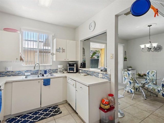 kitchen with a sink, white cabinetry, light countertops, and dishwasher