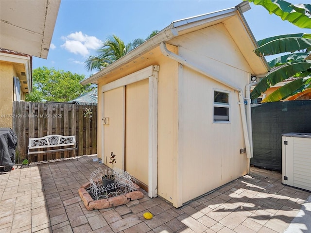 view of shed with fence