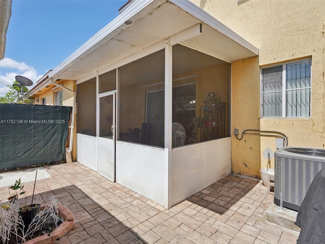 exterior space with cooling unit, a patio area, and stucco siding