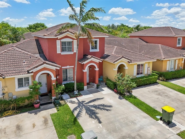 view of front of house with a tile roof and stucco siding