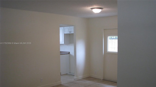 spare room with light tile patterned floors