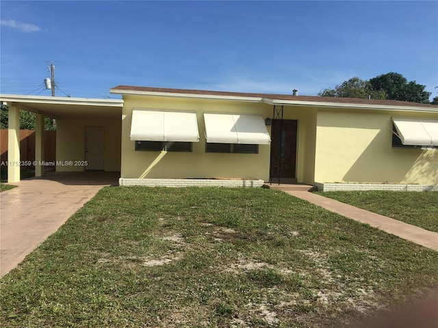 exterior space with a carport, a front yard, and stucco siding