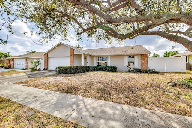 single story home with a garage, driveway, fence, and stucco siding