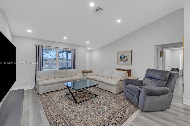 living area with recessed lighting, visible vents, vaulted ceiling, light wood-type flooring, and baseboards