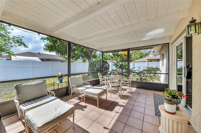 sunroom featuring beamed ceiling and wood ceiling