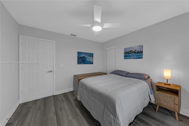 bedroom with baseboards, visible vents, ceiling fan, and wood finished floors