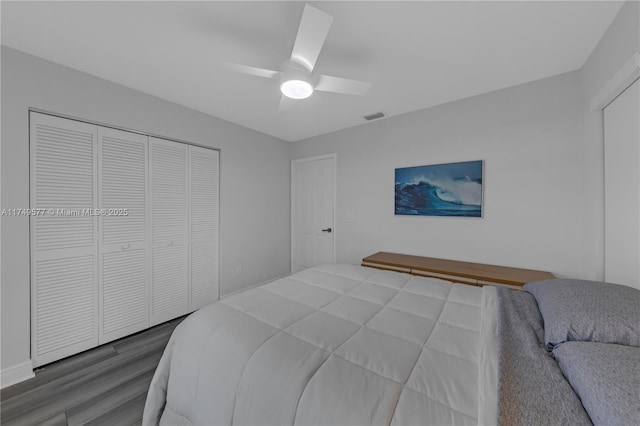 bedroom with ceiling fan, a closet, wood finished floors, and visible vents