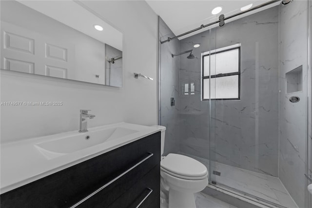 bathroom with marble finish floor, a marble finish shower, recessed lighting, toilet, and vanity