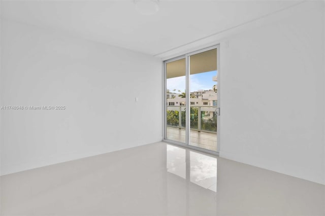 tiled empty room with a wall of windows