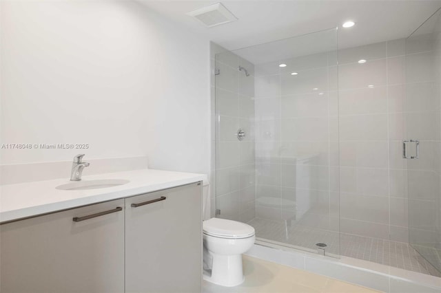 bathroom with visible vents, toilet, vanity, a shower stall, and recessed lighting