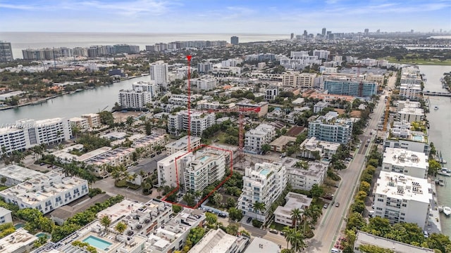 birds eye view of property with a water view and a city view