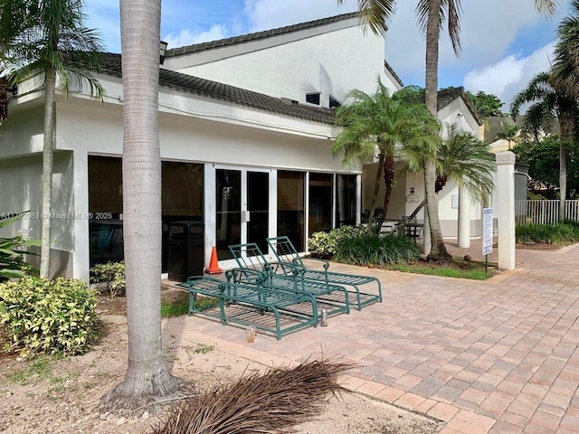 back of house featuring a patio area and stucco siding