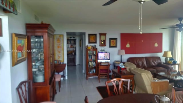 living room featuring ceiling fan and tile patterned floors