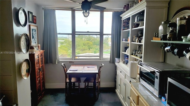 dining room with baseboards and a ceiling fan