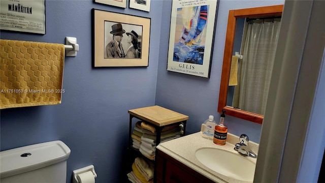 bathroom featuring toilet and vanity