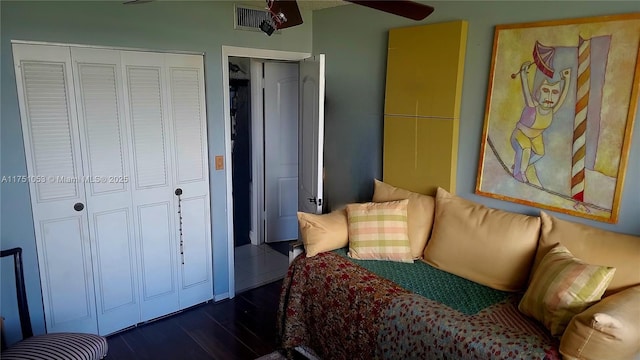 bedroom with dark wood-style floors and visible vents