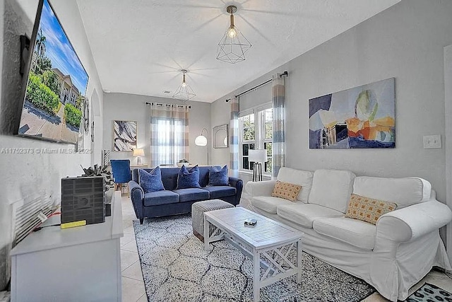living area with vaulted ceiling and light tile patterned floors