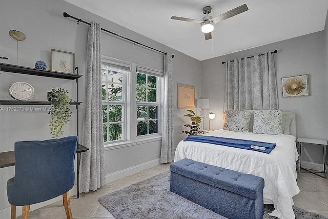 bedroom featuring light tile patterned floors, ceiling fan, and baseboards