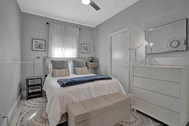 bedroom with baseboards and a ceiling fan
