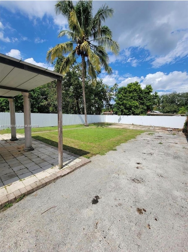 view of yard featuring a patio area and a fenced backyard