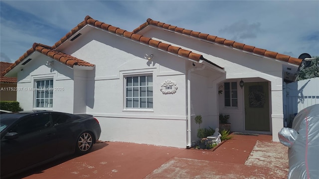 view of side of home with a patio and stucco siding