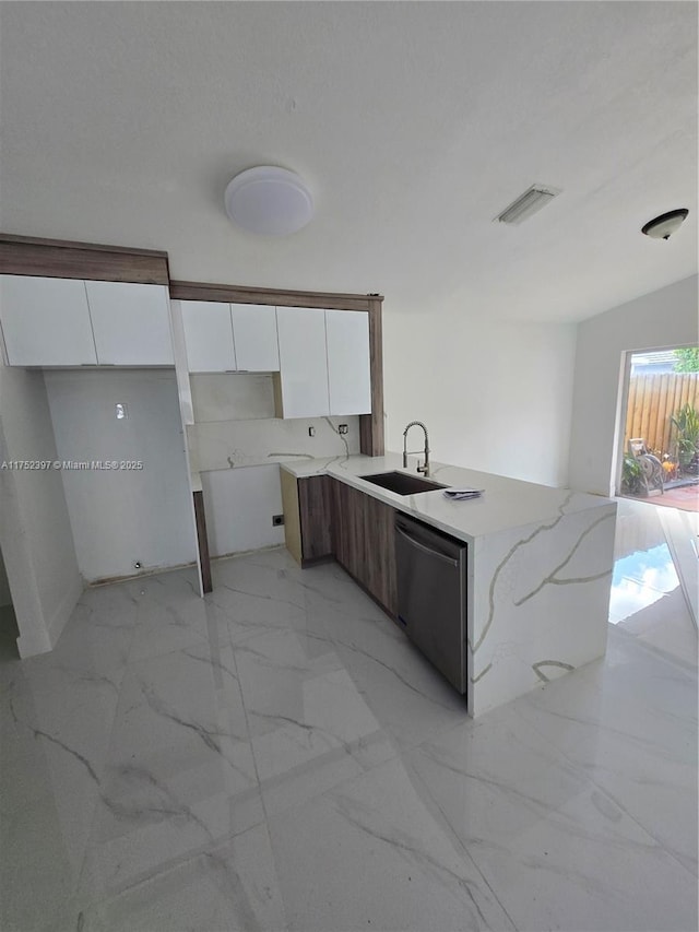 kitchen with marble finish floor, stainless steel dishwasher, modern cabinets, and white cabinetry