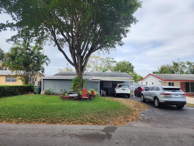 6825 SW 12th St, Pembroke Pines, FL 33023 - view of front of house with asphalt driveway and a front lawn