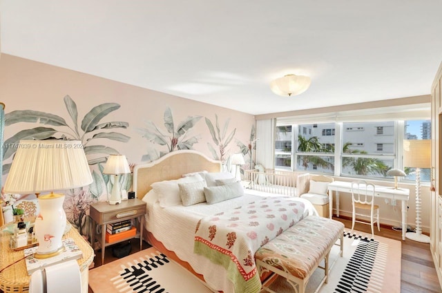 bedroom with multiple windows and wood finished floors