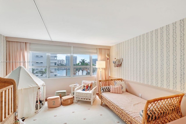 living area with carpet and wallpapered walls