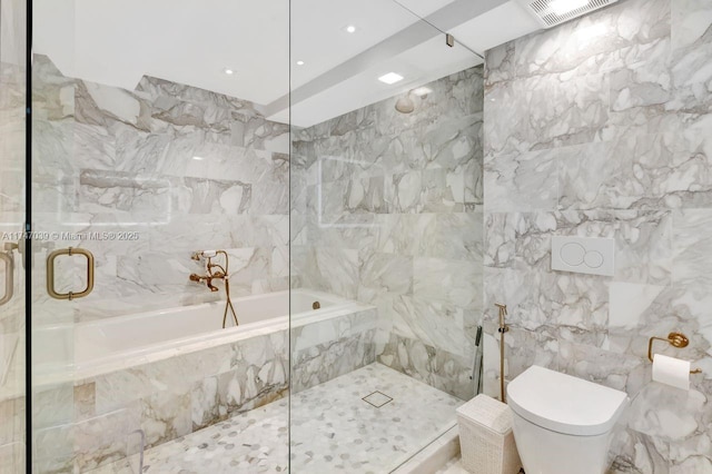 bathroom featuring visible vents, toilet, a shower with door, a garden tub, and tile walls