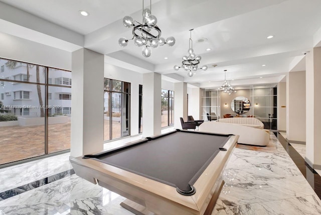 playroom with pool table, marble finish floor, a tray ceiling, a notable chandelier, and recessed lighting