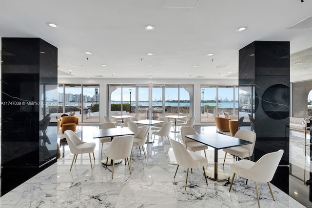 dining area featuring recessed lighting and marble finish floor