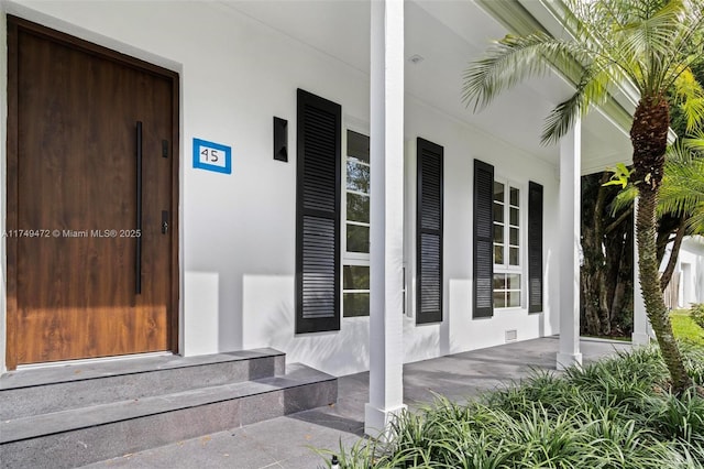 property entrance with stucco siding