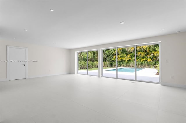 empty room with recessed lighting and baseboards