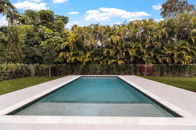 view of swimming pool featuring a fenced in pool, a fenced backyard, and a lawn