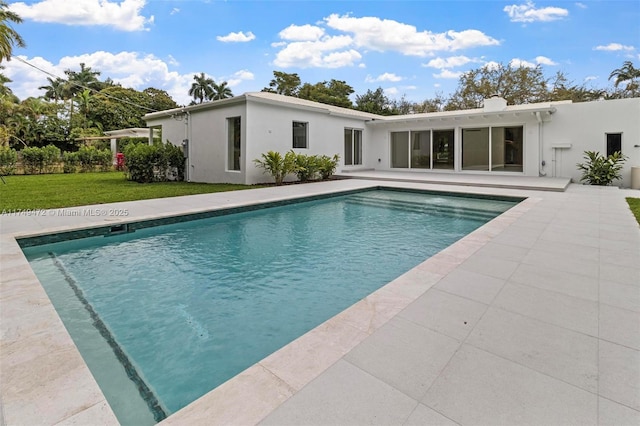 outdoor pool featuring a yard and a patio