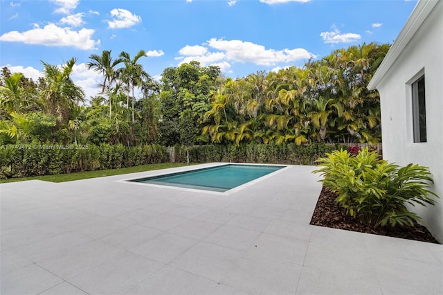 outdoor pool featuring a fenced backyard and a patio