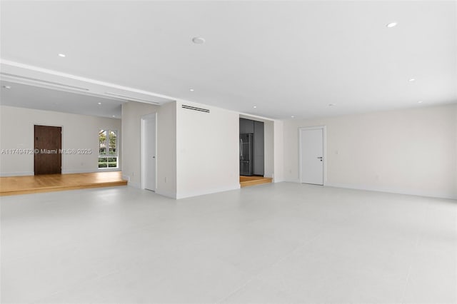 spare room featuring baseboards and recessed lighting