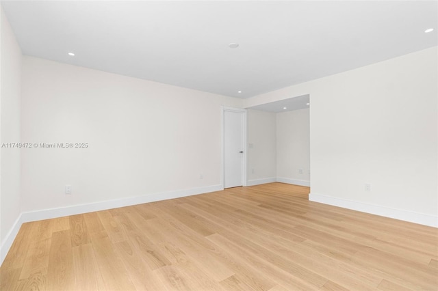 empty room with recessed lighting, baseboards, and light wood finished floors