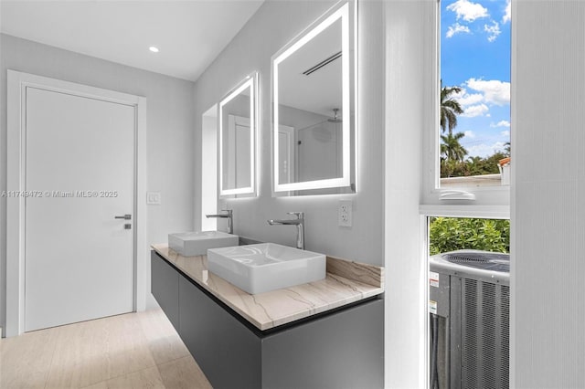 full bath featuring double vanity, a closet, and a sink