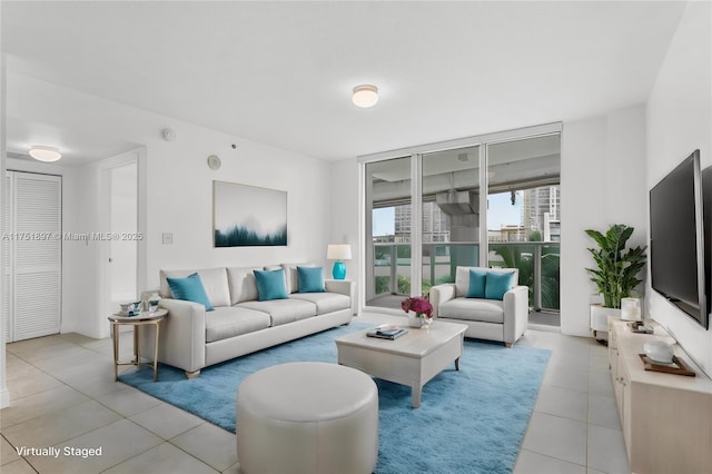 living area with light tile patterned floors and floor to ceiling windows