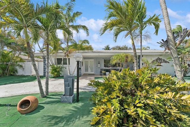 view of front of home with fence and french doors