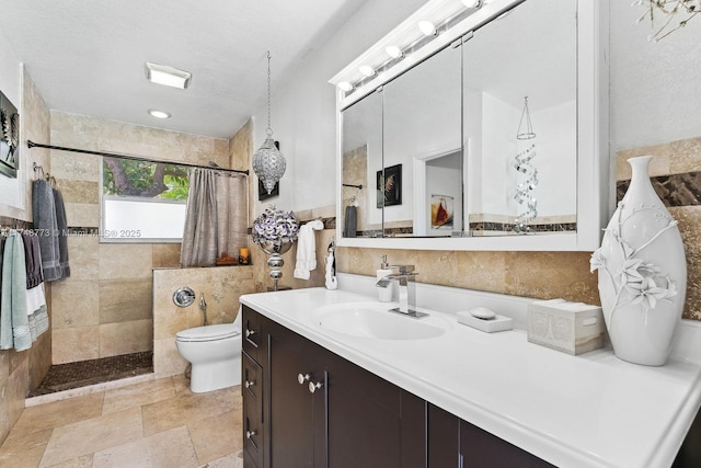 bathroom with a walk in shower, a textured ceiling, toilet, stone tile floors, and vanity