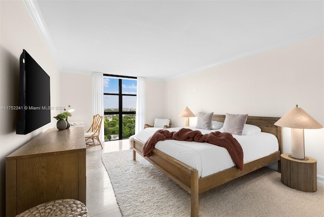 bedroom featuring ornamental molding and a wall of windows