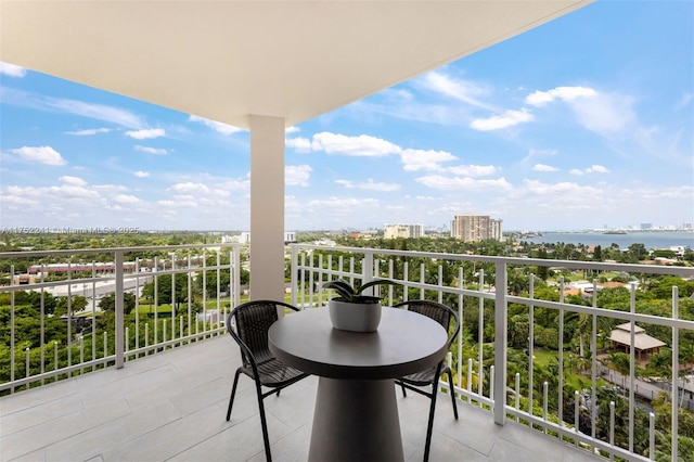 balcony with a water view and a city view