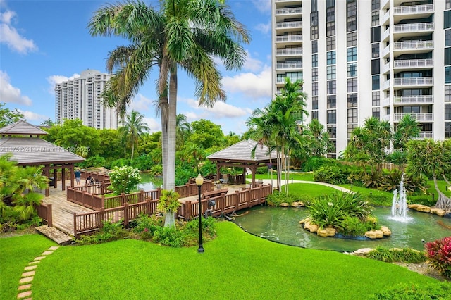 exterior space featuring a water view, a lawn, and a gazebo