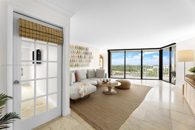 living room featuring a wall of windows, light tile patterned flooring, and ornamental molding